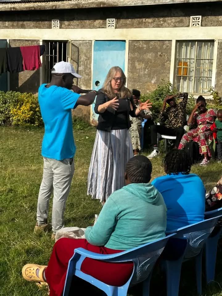 A facilitator speaking with community members
