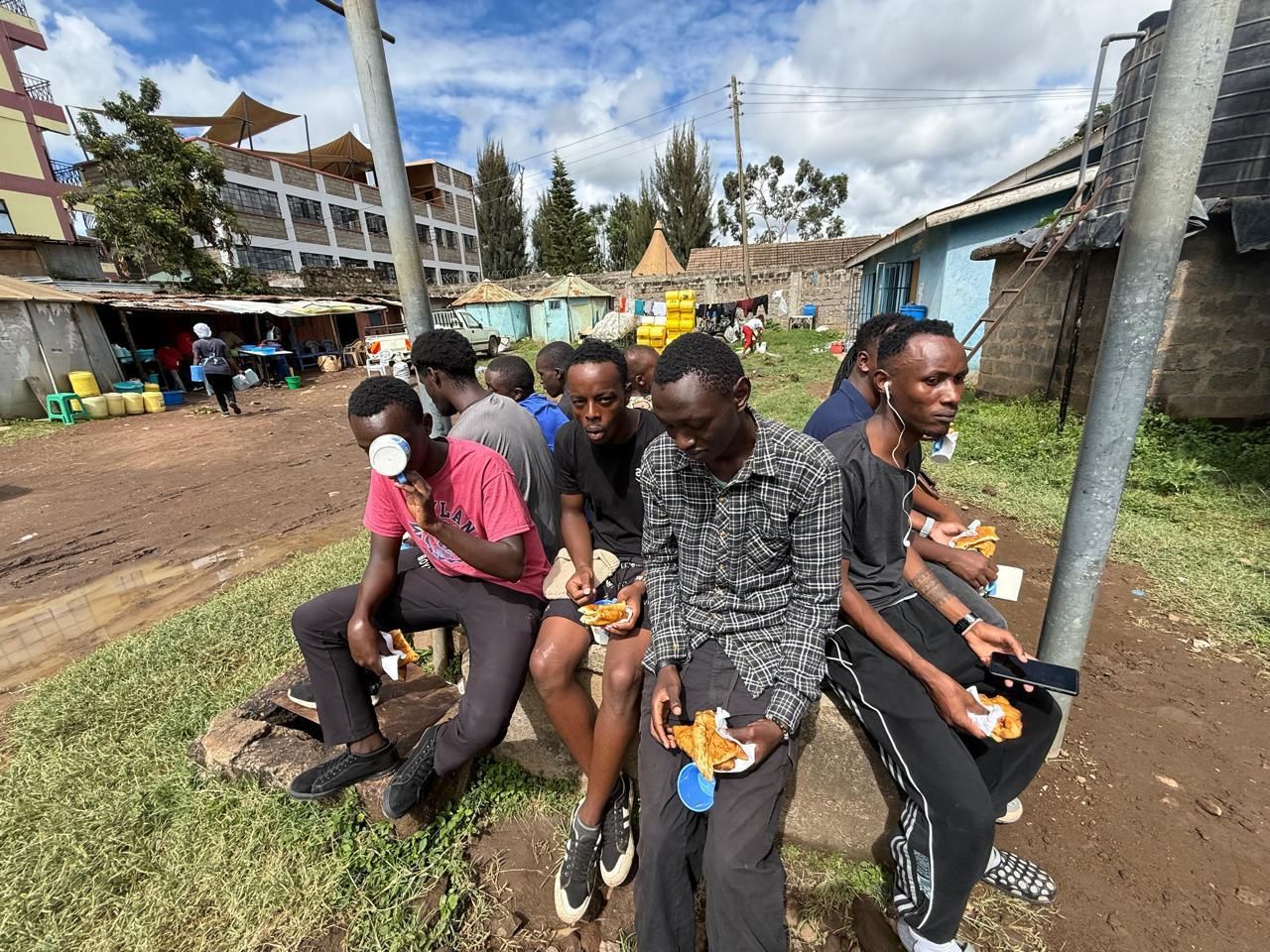 Young men sharing a meal outdoors