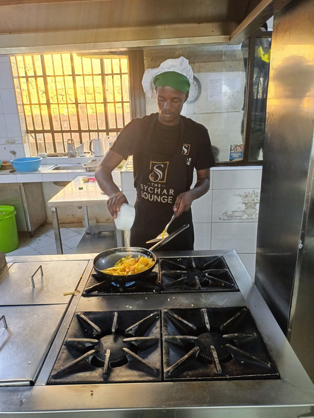 A young chef cooking in a professional kitchen